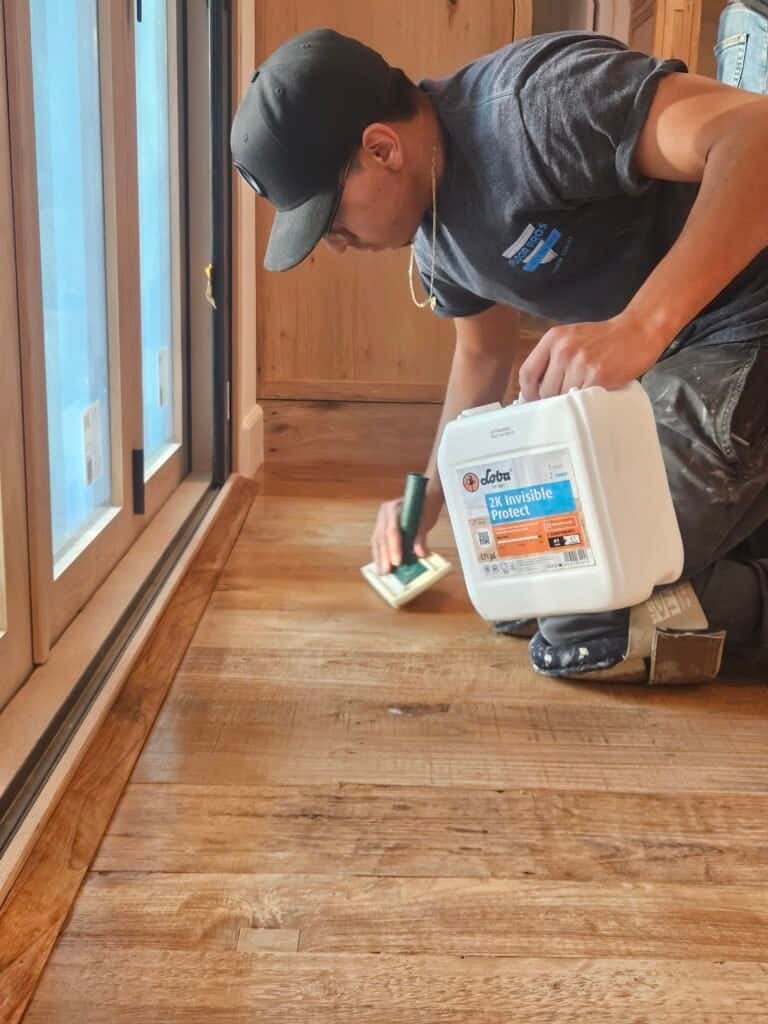 Natural hardwood flooring installation by professional in a residential setting.